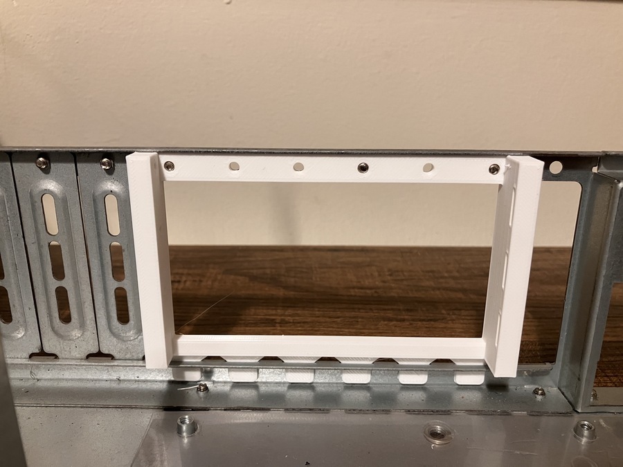 Photo of the printed part installed in the read of the chassis