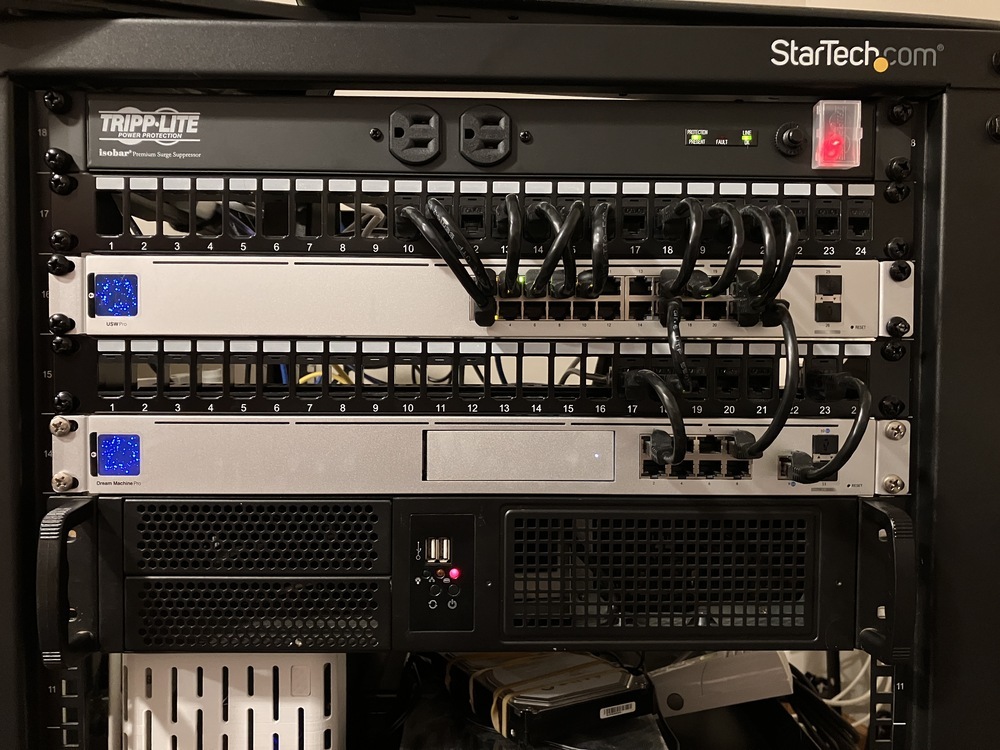 Front view of the server rack showing the same network components as before, but now with an additional 2U server at the bottom.