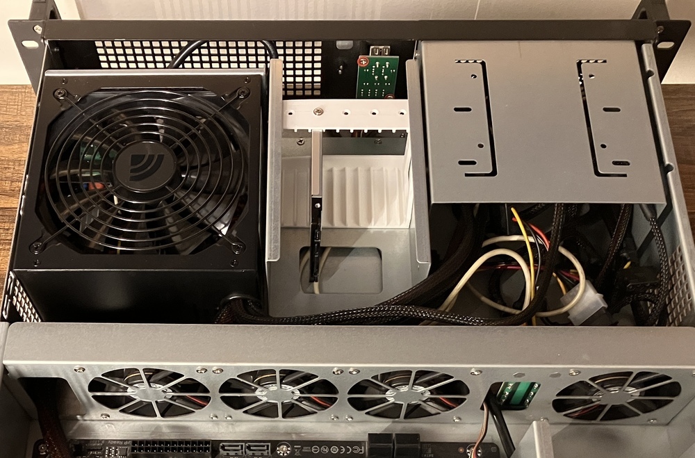 Test fitting with a single SSD was a success. At the bottom you can see how little space is between the north-facing SATA ports and the fan wall